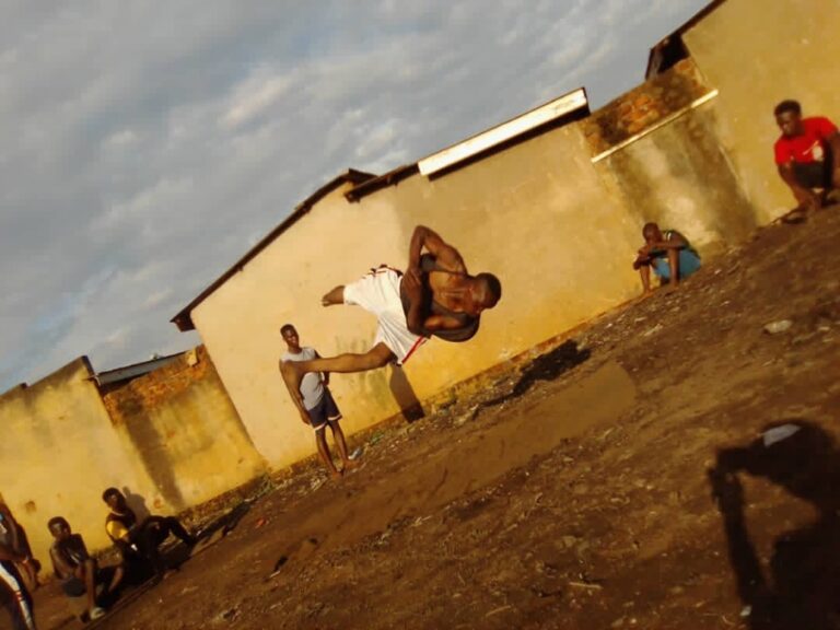 A student flipping in mid air as part of a performance
